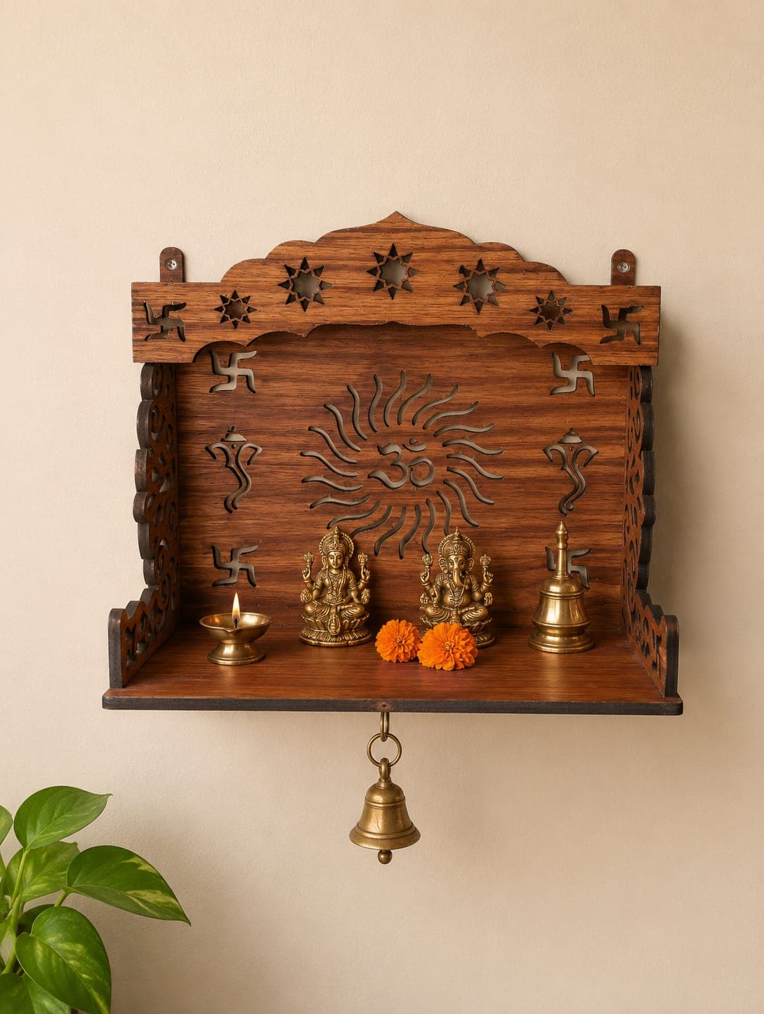 Wall-mounted pooja mandir shelf with carved Om and Ganesh motifs